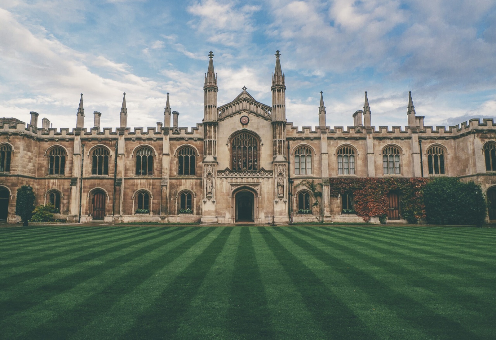A traditional college courtyard framed by Gothic architecture